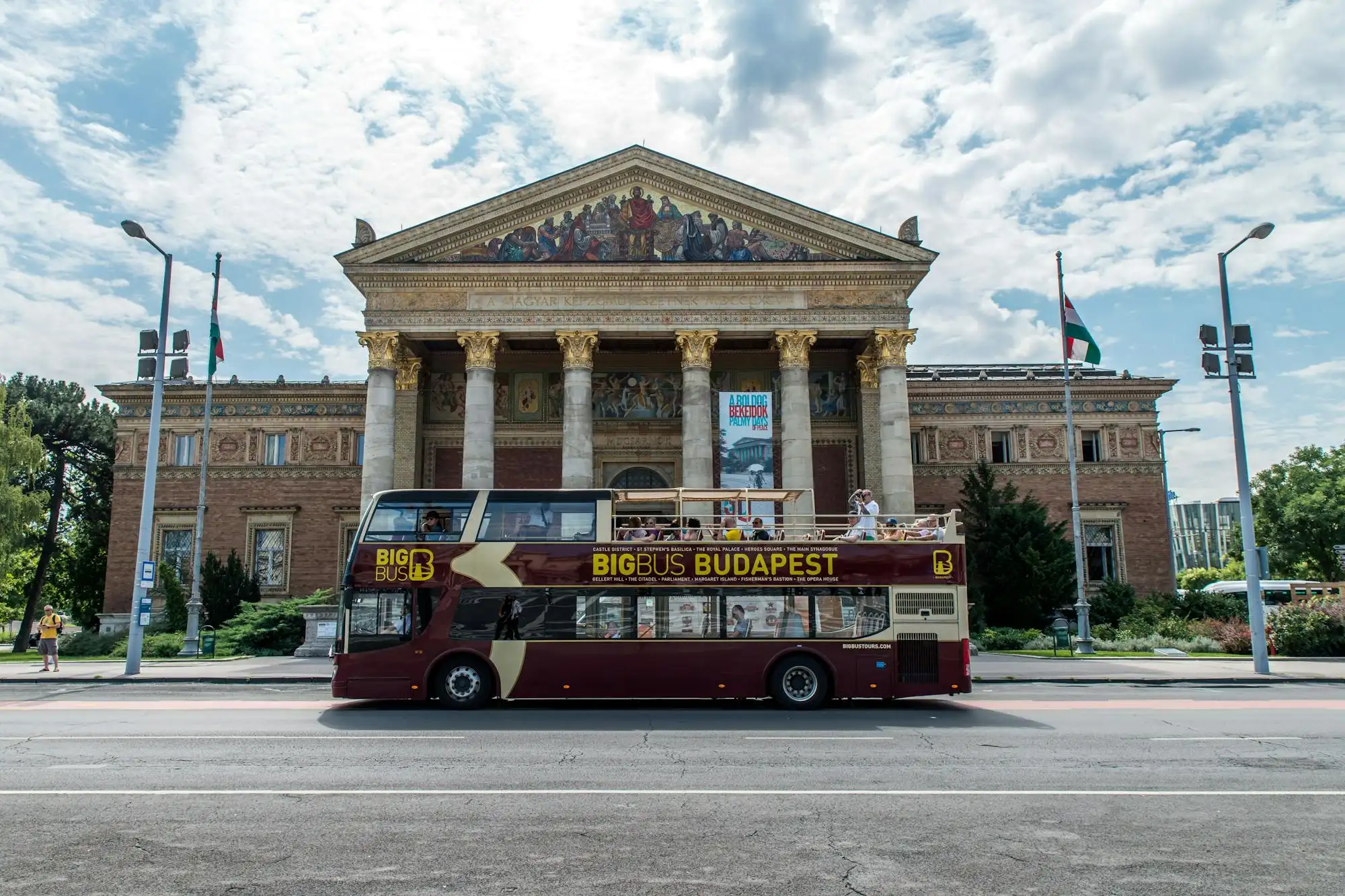 A Big Bus double-decker passing the Műcsarnok, the Hall of Art, on Heroes' Square in Budapest