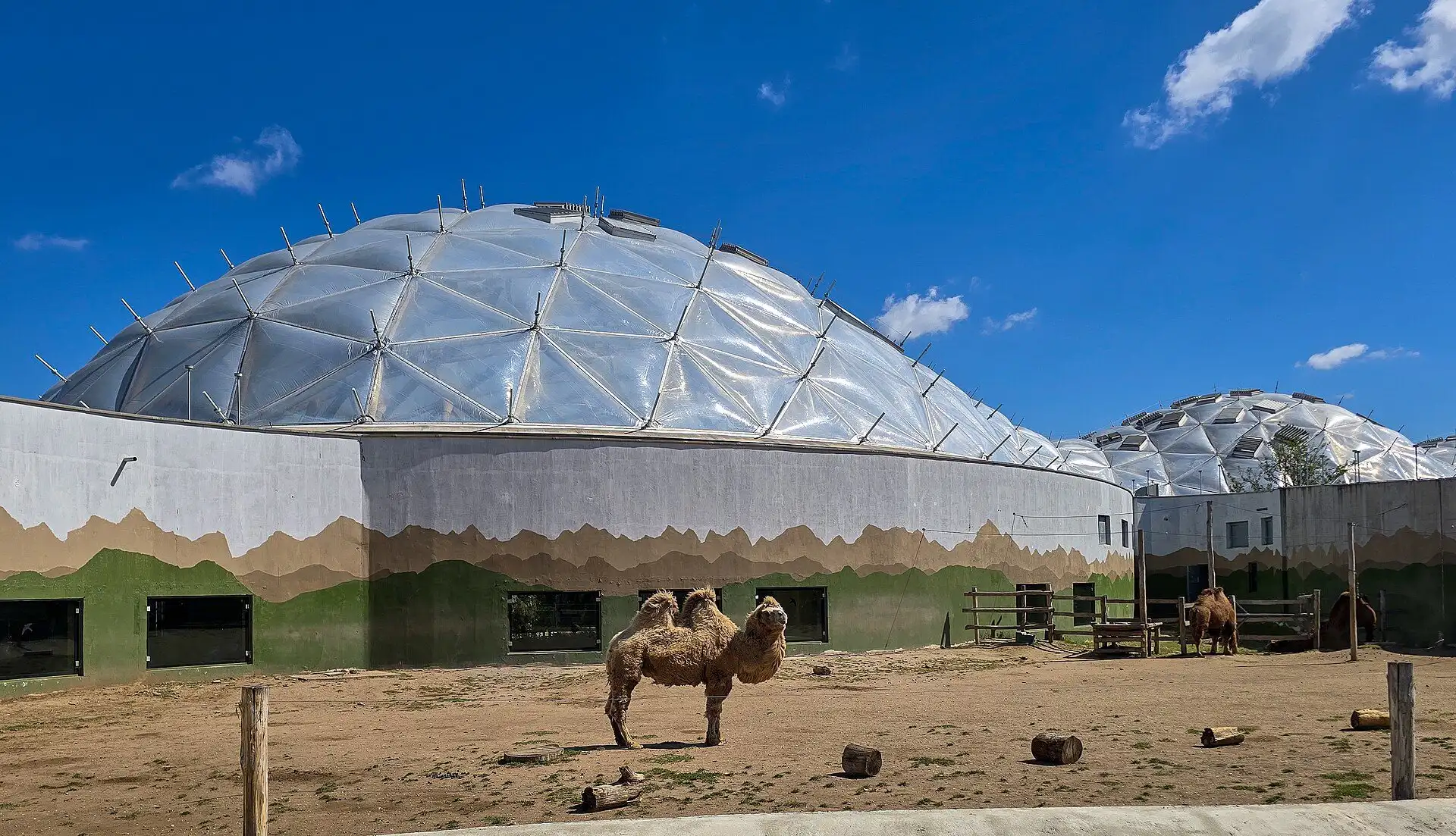 The white domed roof of the Biodome at Budapest Zoo seen across an outdoor enclosure
