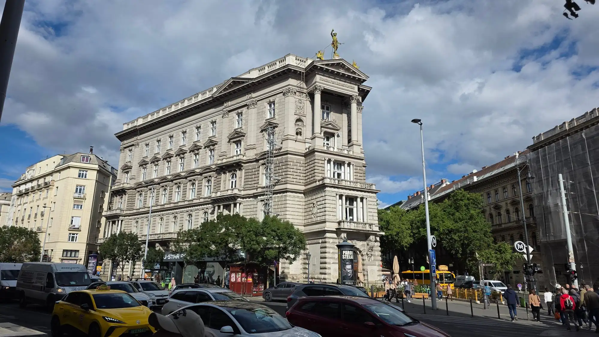 The Fonciére Palace at the start of Andrássy Avenue in Budapest, a corner block with a tower and a gilded figure on its roof