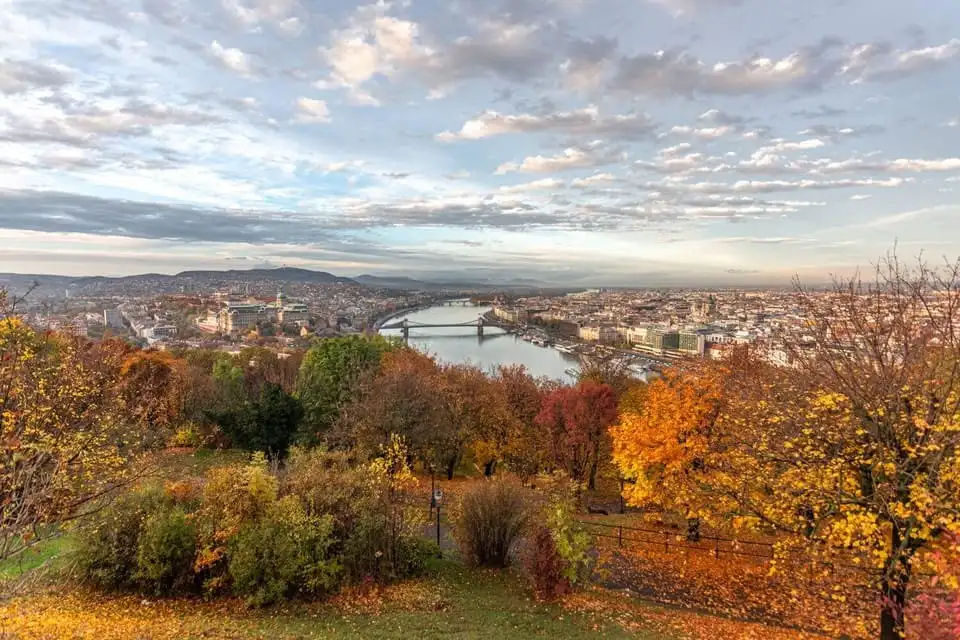 The wooded slopes of Gellért Hill in autumn colour, looking down over the Danube towards the Chain Bridge and Buda Castle