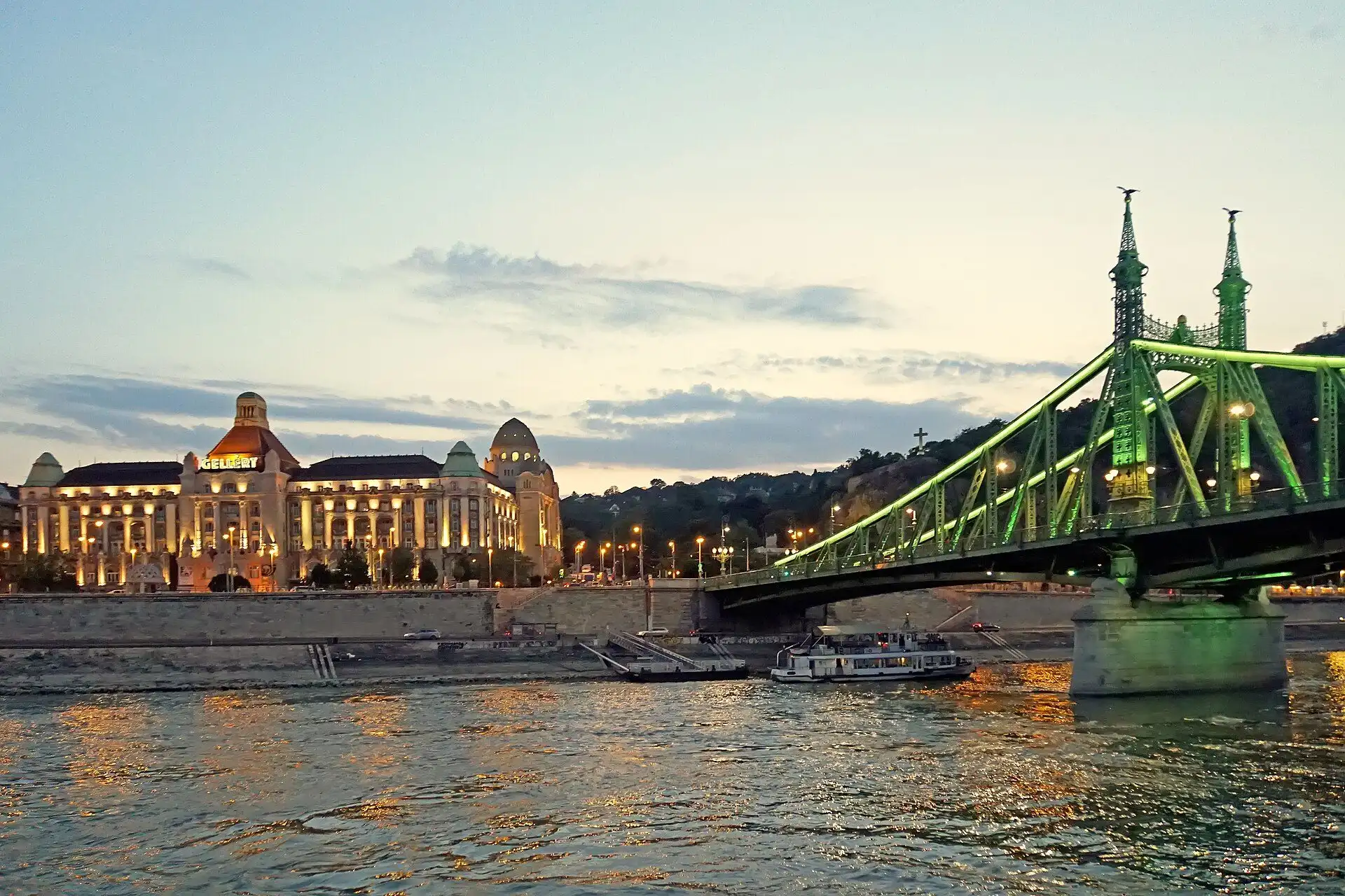 The Gellért Hotel and Liberty Bridge at dusk, seen across the Danube from the Pest embankment