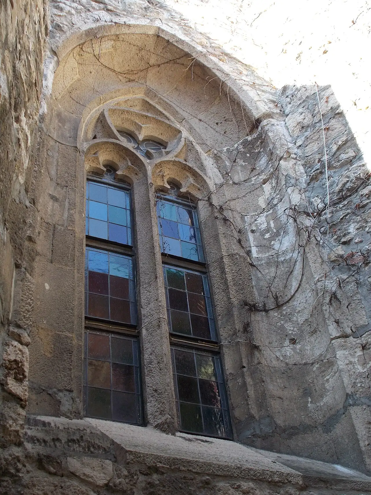 The traceried Gothic window of the Gothic Hall, seen from outside in the castle wall below Buda Castle