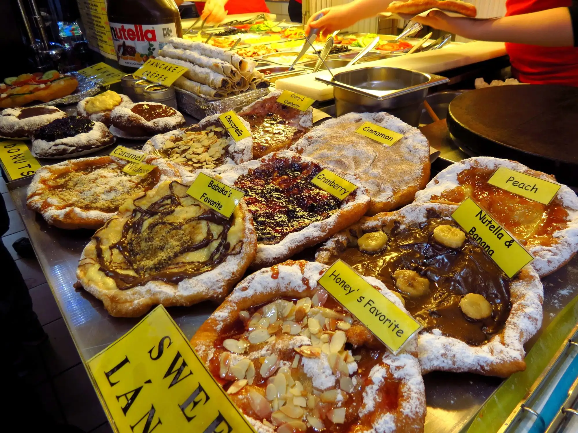 Sweet lángos with different toppings laid out on a counter at the Great Market Hall in Budapest