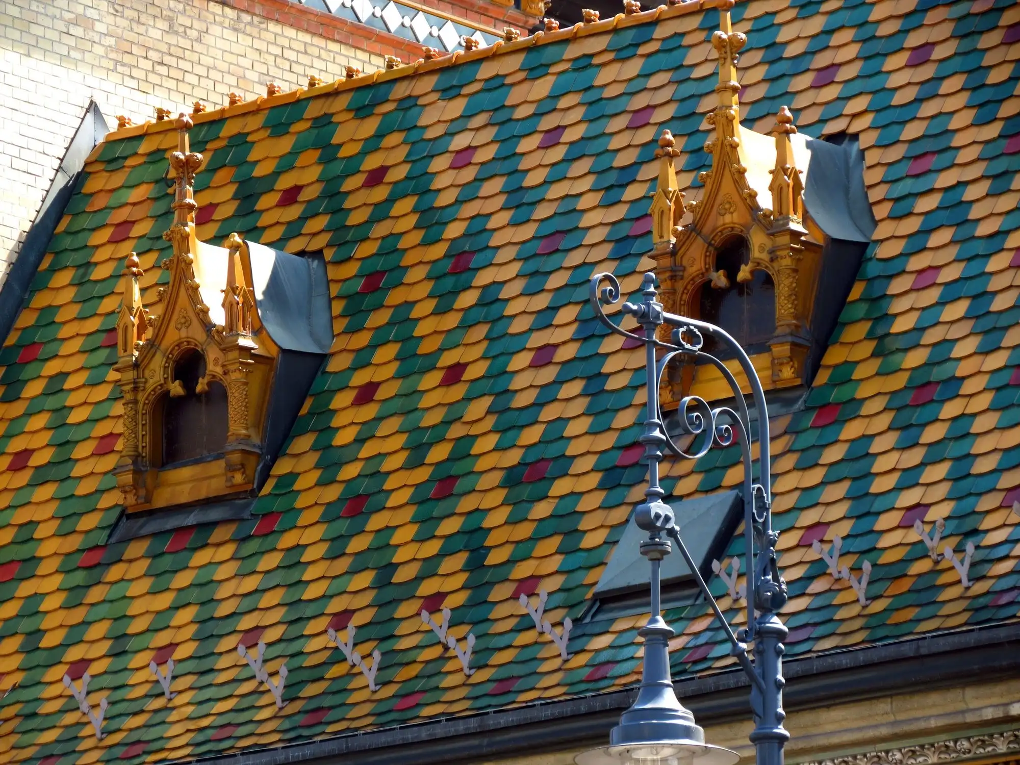 Coloured Zsolnay roof tiles and gilded dormer windows on the roof of the Great Market Hall in Budapest