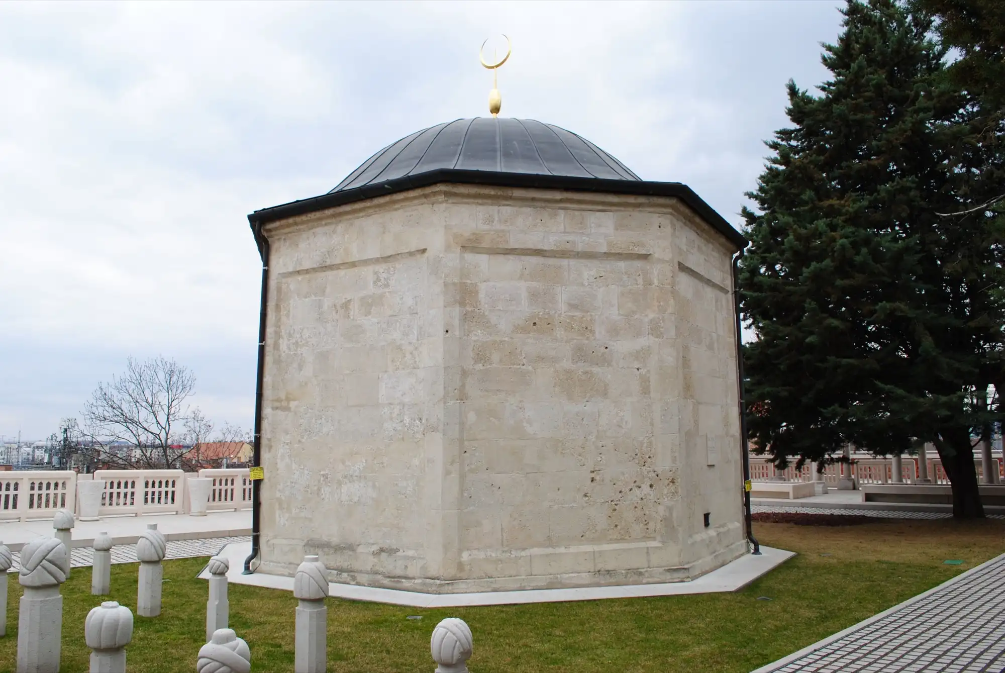 The octagonal stone tomb of Gül Baba with its lead dome and crescent finial, on its terrace among Ottoman turban-topped gravestones