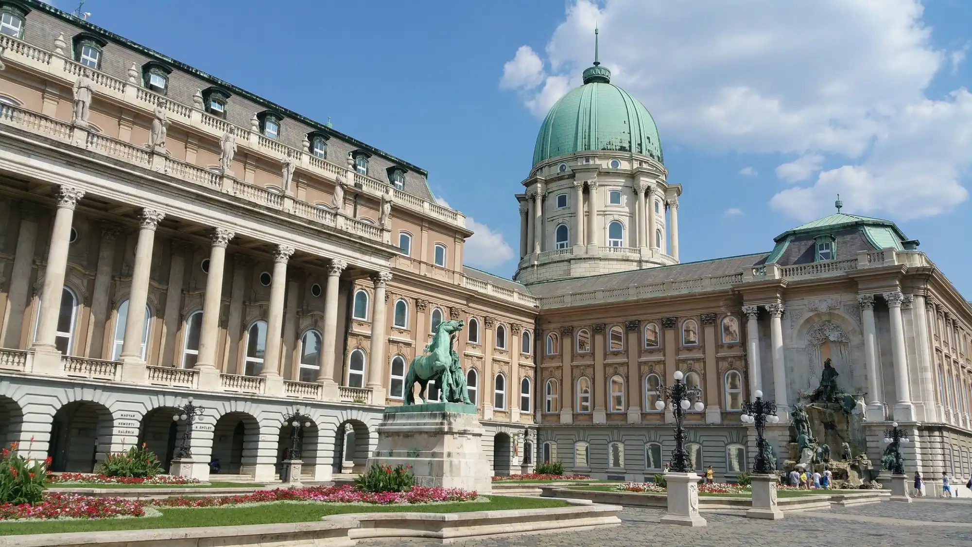 The Hunyadi Court of Buda Castle in sunshine: the dome of the Royal Palace, the Csikós horse-herd statue and the Matthias Fountain