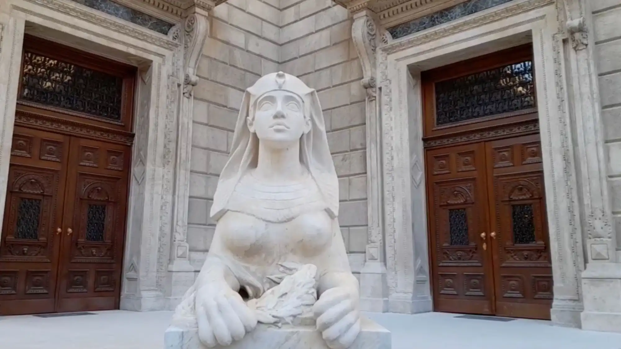 A statue in front of the ornate doors at the Hungarian State Opera House in Budapest, Hungary.