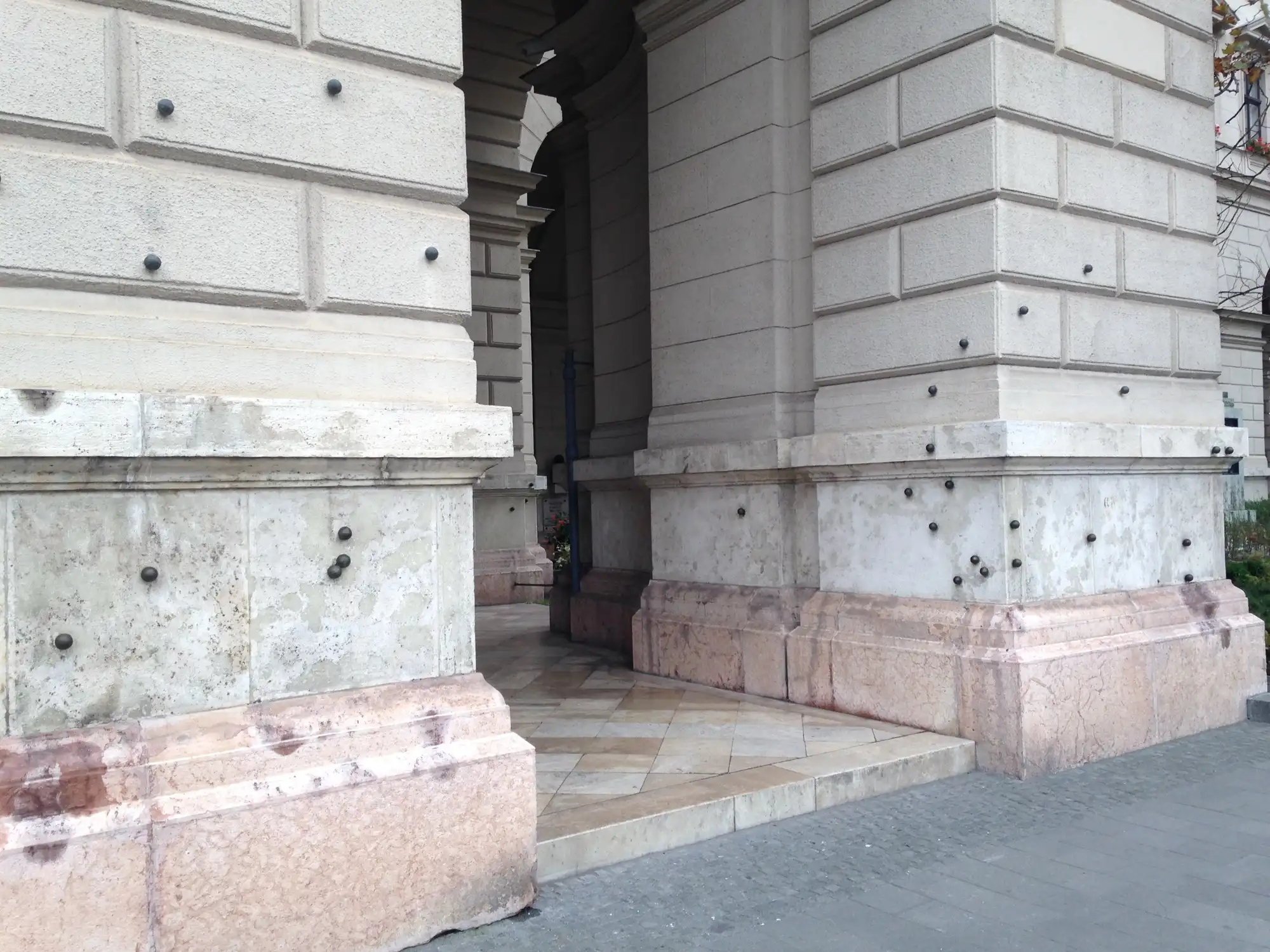 Bronze balls set into the stone arcade of the Ministry of Agriculture on Kossuth Lajos tér, marking bullet holes from 25 October 1956