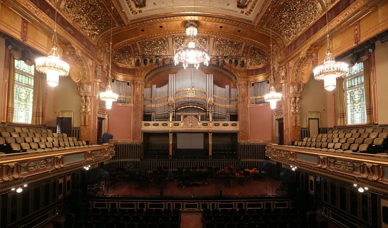 The Grand Hall of the Liszt Academy, with gilded ceilings, crystal chandeliers, stained-glass windows and the organ above the stage