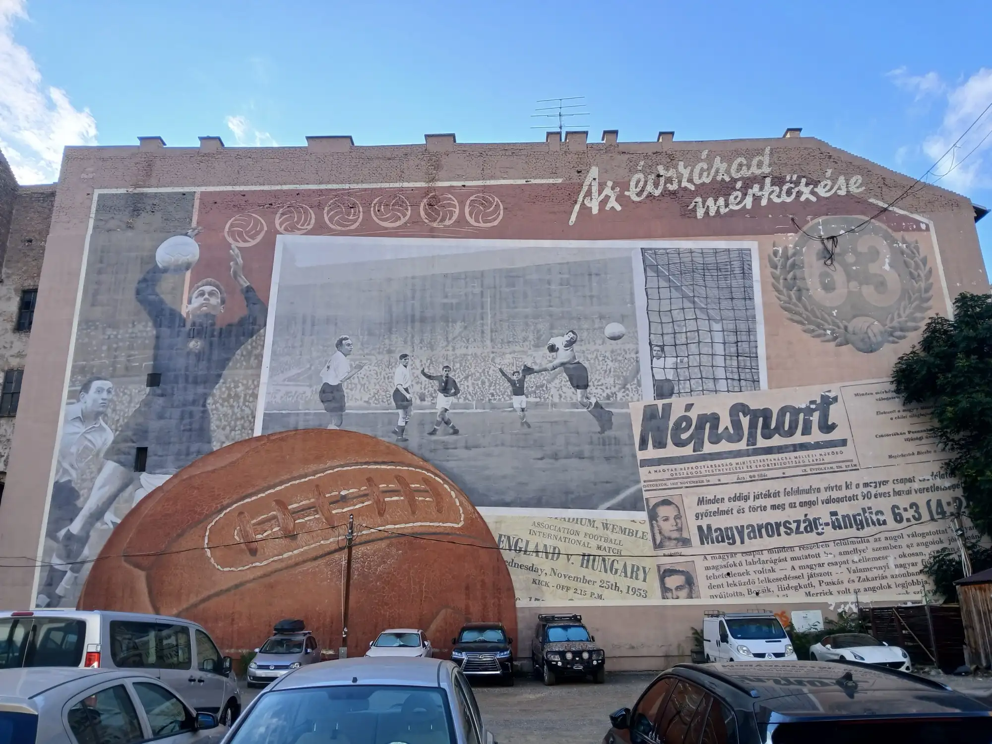 The 6:3 mural on a firewall on Rumbach Sebestyén utca in Budapest, with a goalkeeper, a match scene, a giant leather ball and a Népsport front page celebrating Hungary's 1953 win at Wembley