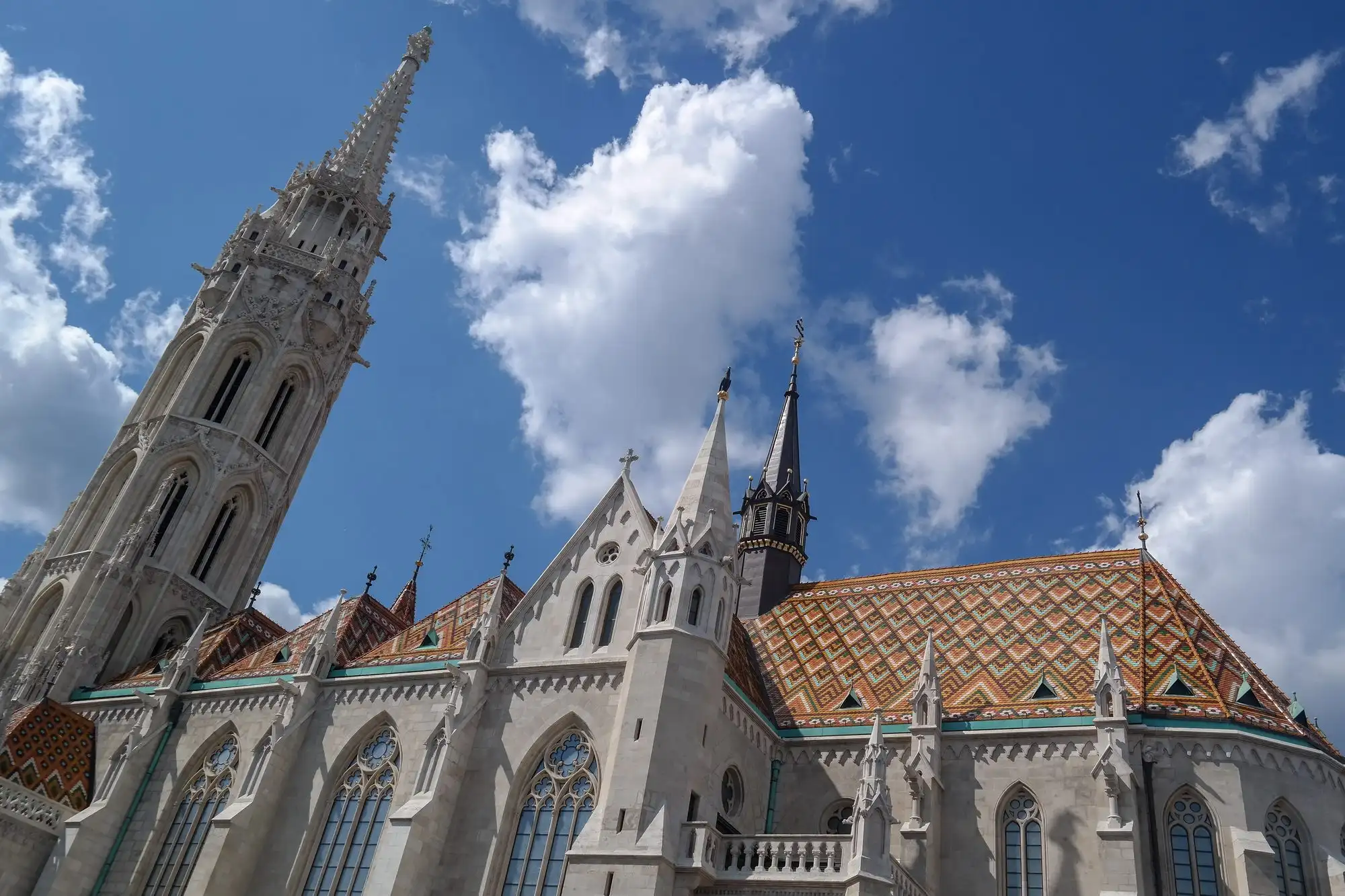 The south side of Matthias Church from Szentháromság tér, with the Mary Gate porch, the tiled roof and the Matthias Tower