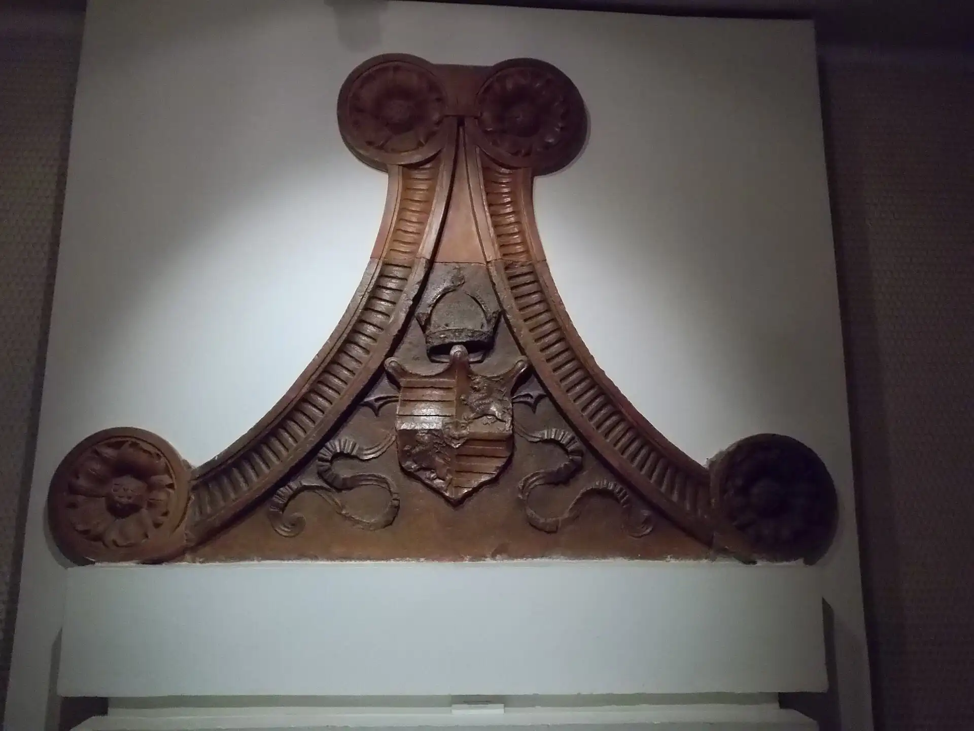 A red marble pediment carved with the coat of arms of King Matthias, from the late fifteenth-century royal palace, on display at the Budapest History Museum