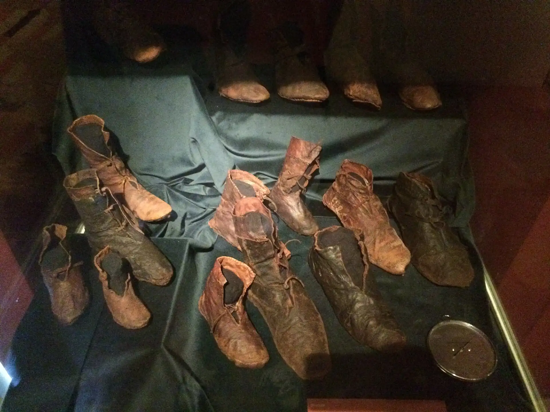 Fourteenth-century leather shoes from a well at the Teleki Palace site, laid out in a display case at the Budapest History Museum