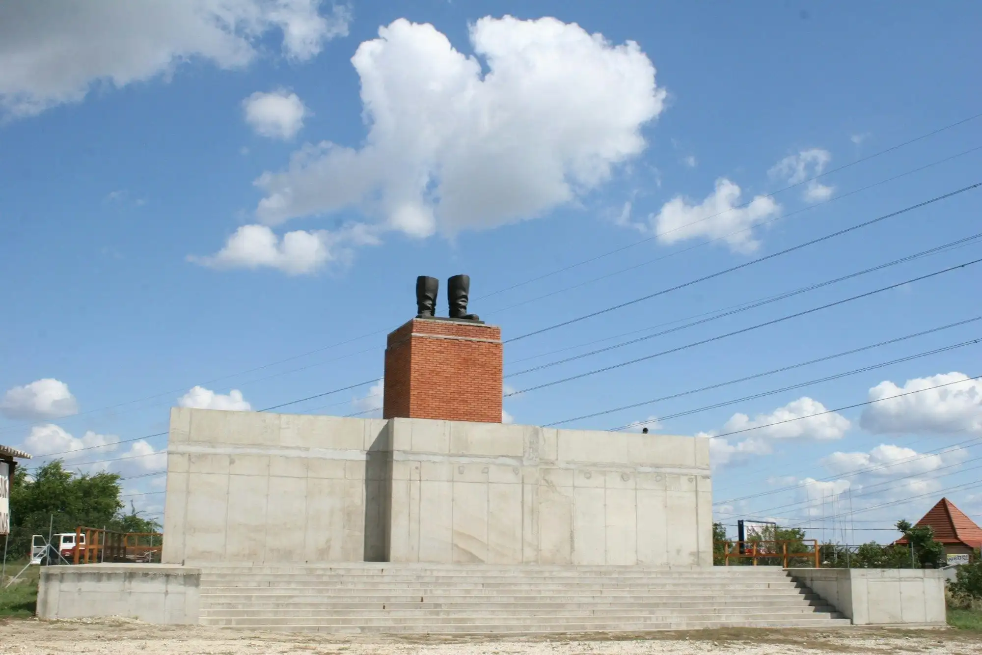 The full-size replica of Stalin's grandstand at Memento Park, with the bronze boots on a brick plinth on top