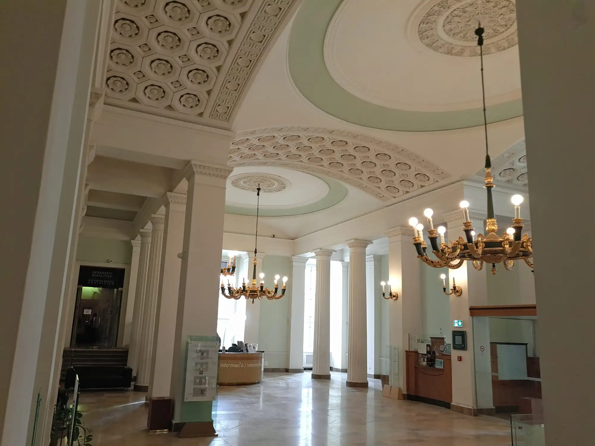 The entrance hall of the Hungarian National Museum, with the ticket desks under a coffered ceiling