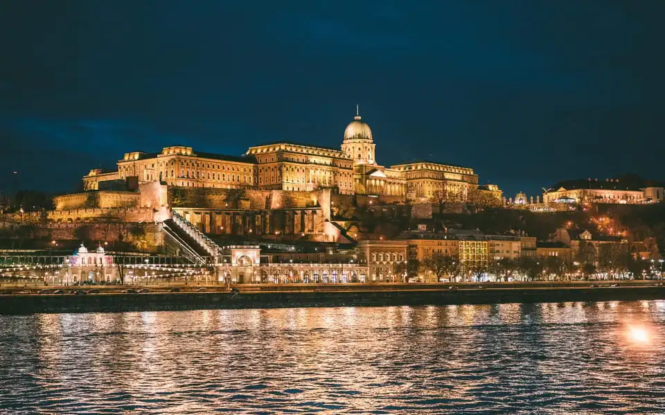Buda Castle floodlit at night, seen from the Danube on the night cruise
