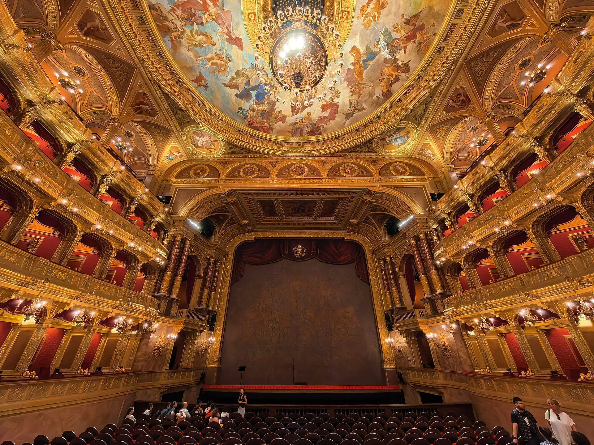 The horseshoe auditorium of the Hungarian State Opera House, with three tiers of gilded boxes curving round towards the stage