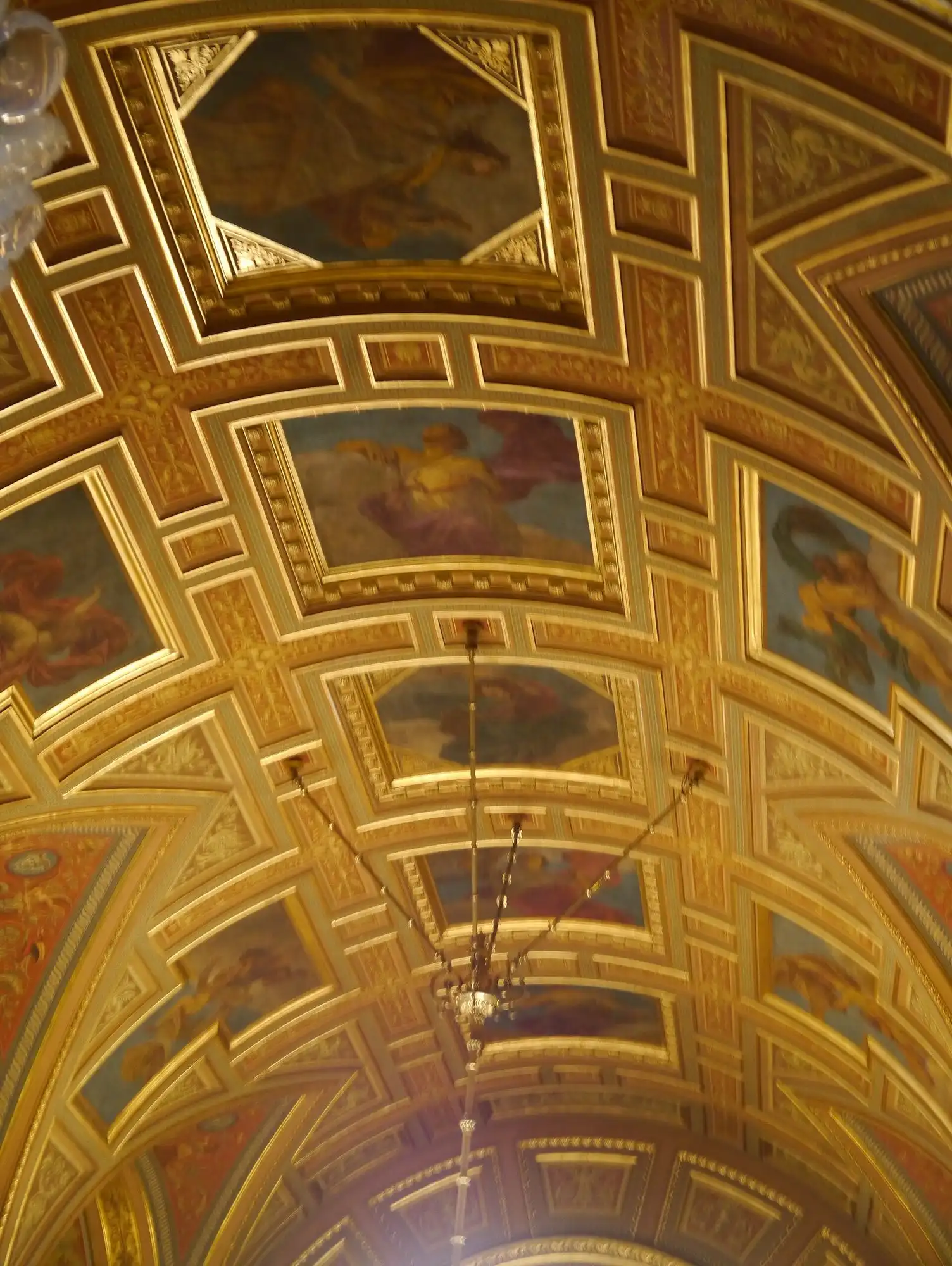The gilded coffered ceiling of the Opera House foyer, with painted panels of the nine muses between the gold ribs