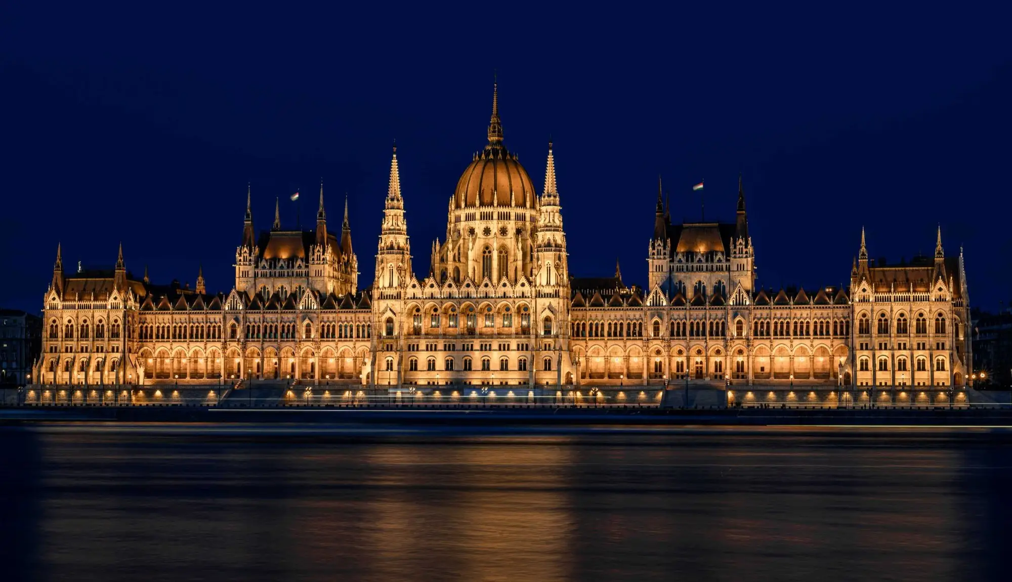 The Hungarian Parliament floodlit at dusk, reflected in the Danube
