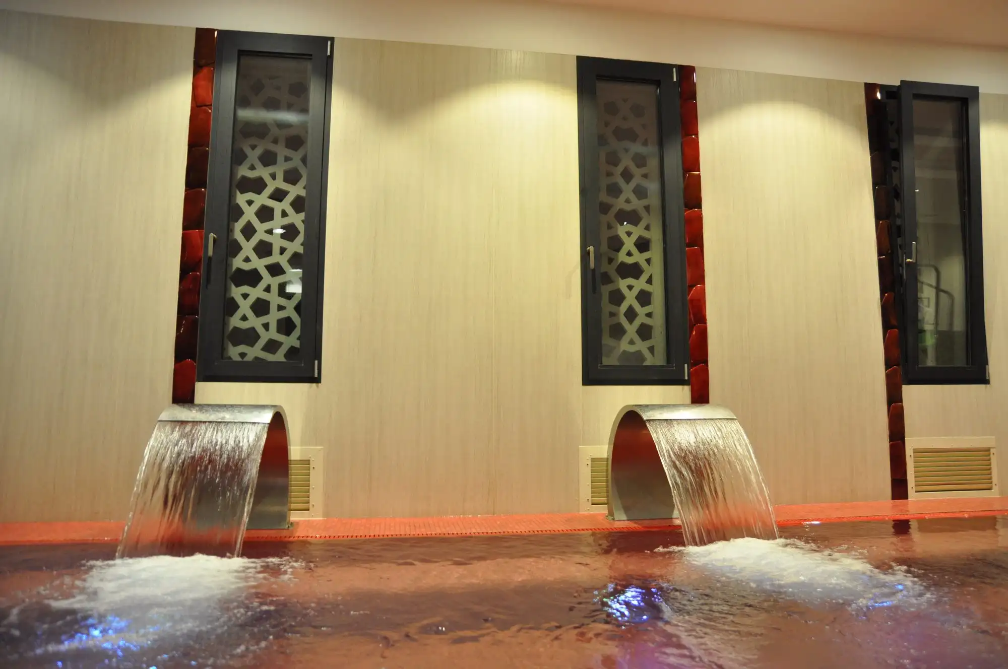 Neck showers pouring into a warm pool in the wellness section at Rudas Thermal Bath