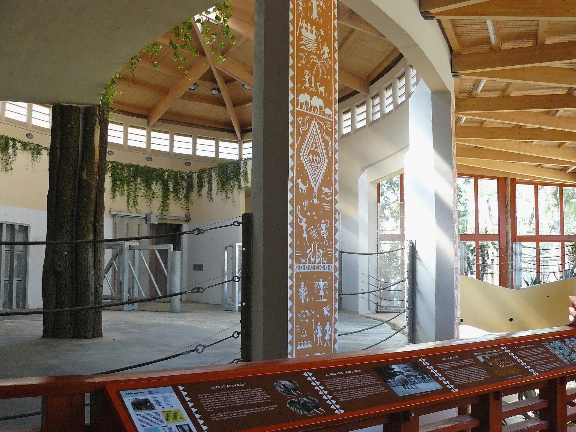 Inside the Savannah House at Budapest Zoo, with its timber roof, painted column and clerestory windows over the indoor enclosures