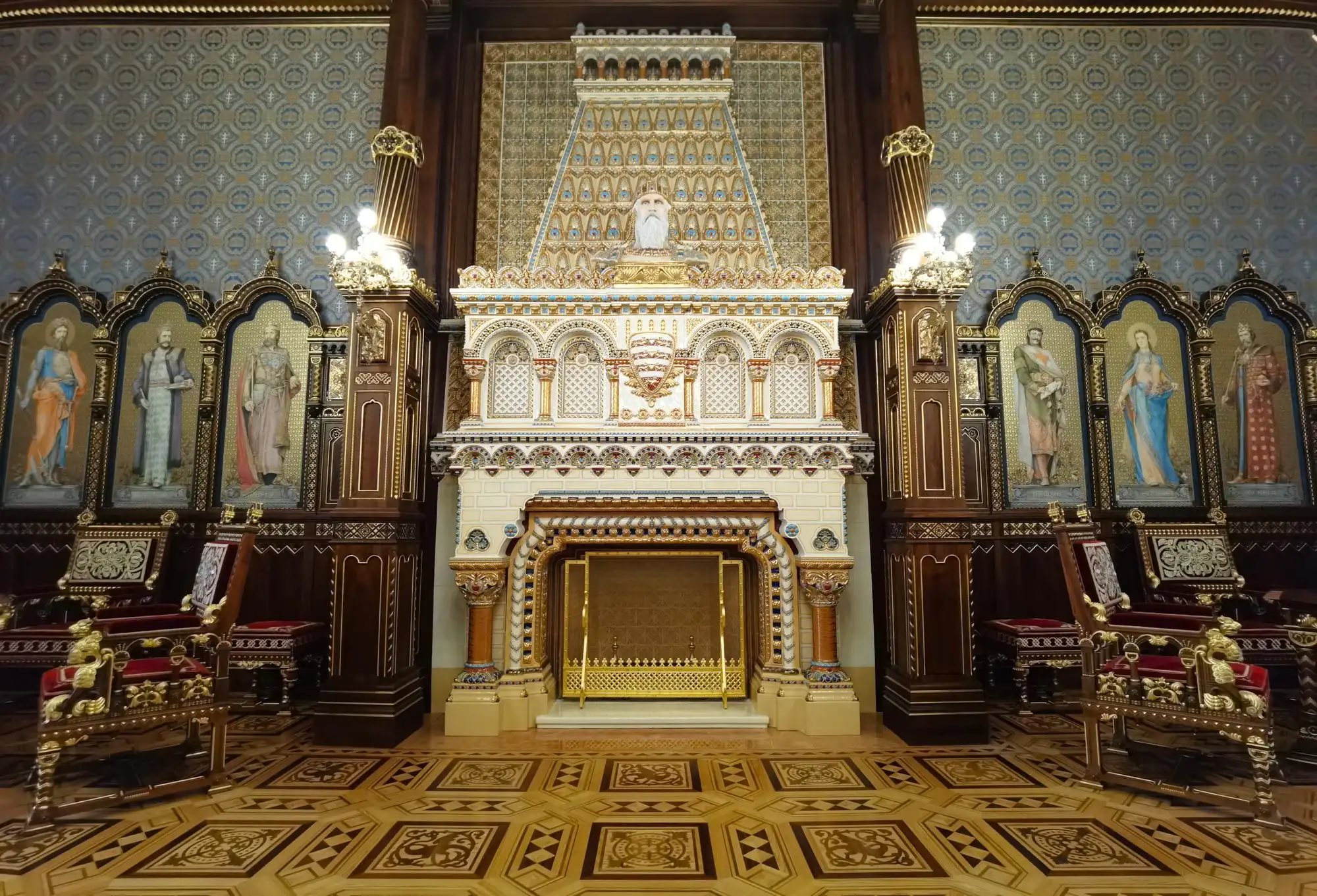 The reconstructed St Stephen's Hall in Buda Castle, with its white Zsolnay ceramic fireplace, carved walnut panelling and painted portraits of Hungary's Árpád kings
