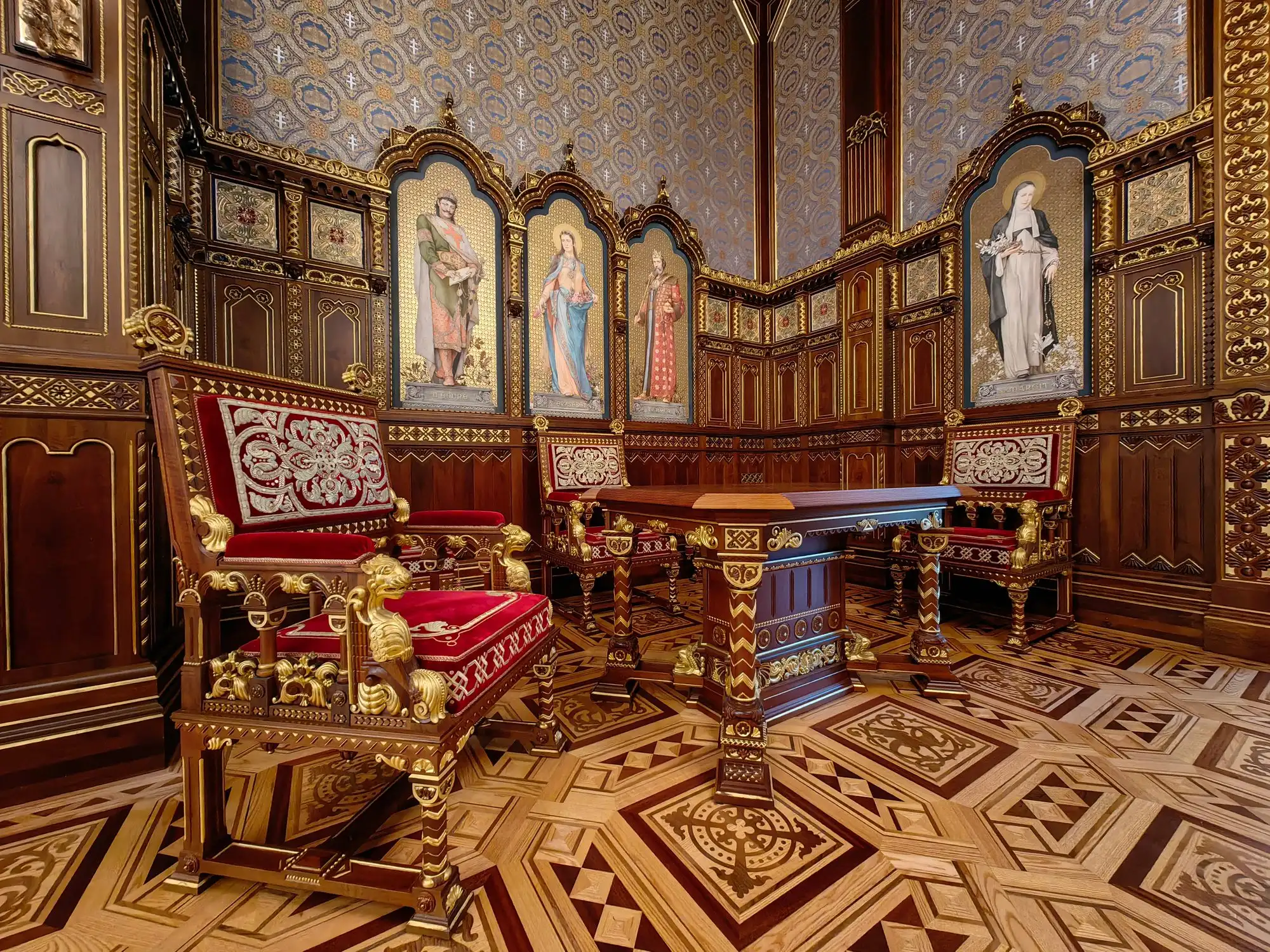 St Stephen's Hall in Buda Castle: carved wooden panelling, a chandelier and painted portraits of Hungarian kings in gilded frames