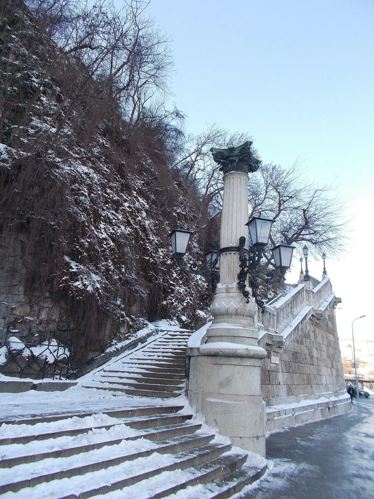 The Szent Gellért steps climbing the rock face of Gellért Hill in winter, with ornate lamp standards along the stone balustrade