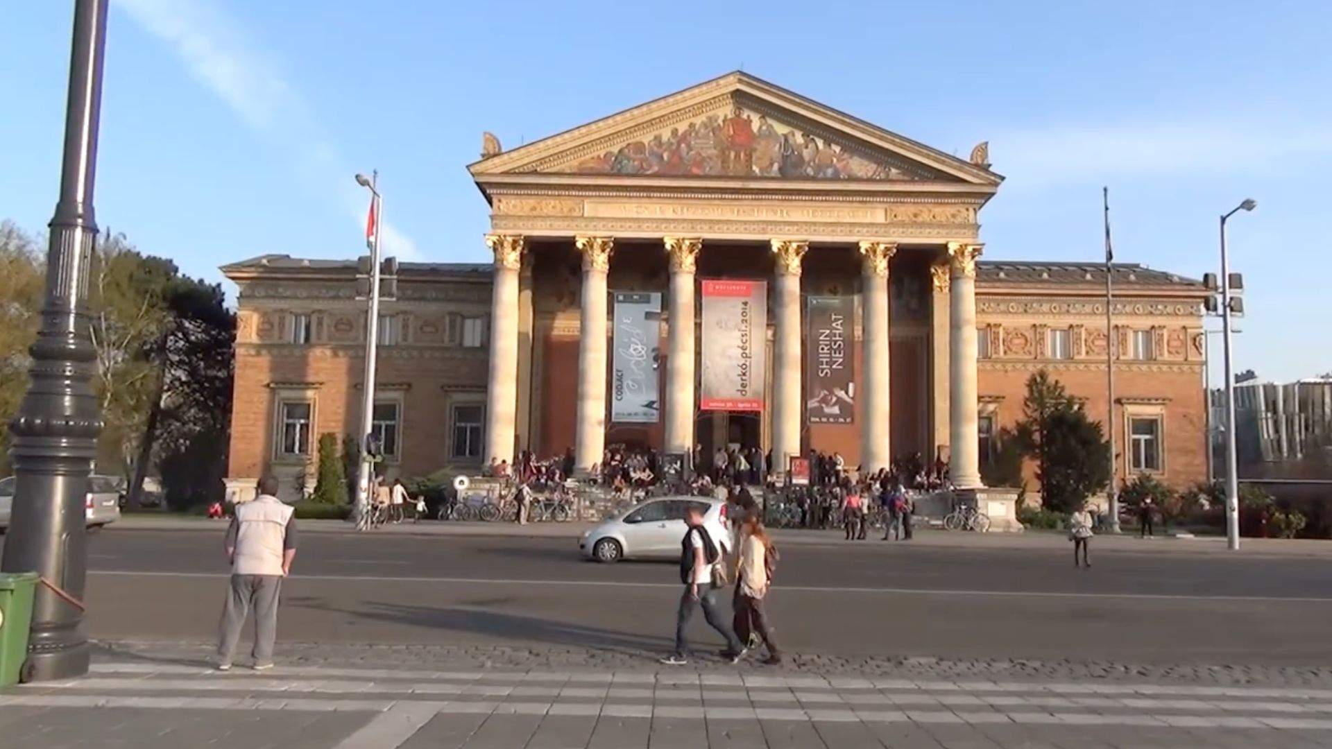 Front view of the Kunsthalle building in Budapest, Hungary, with people walking and gathering in front.