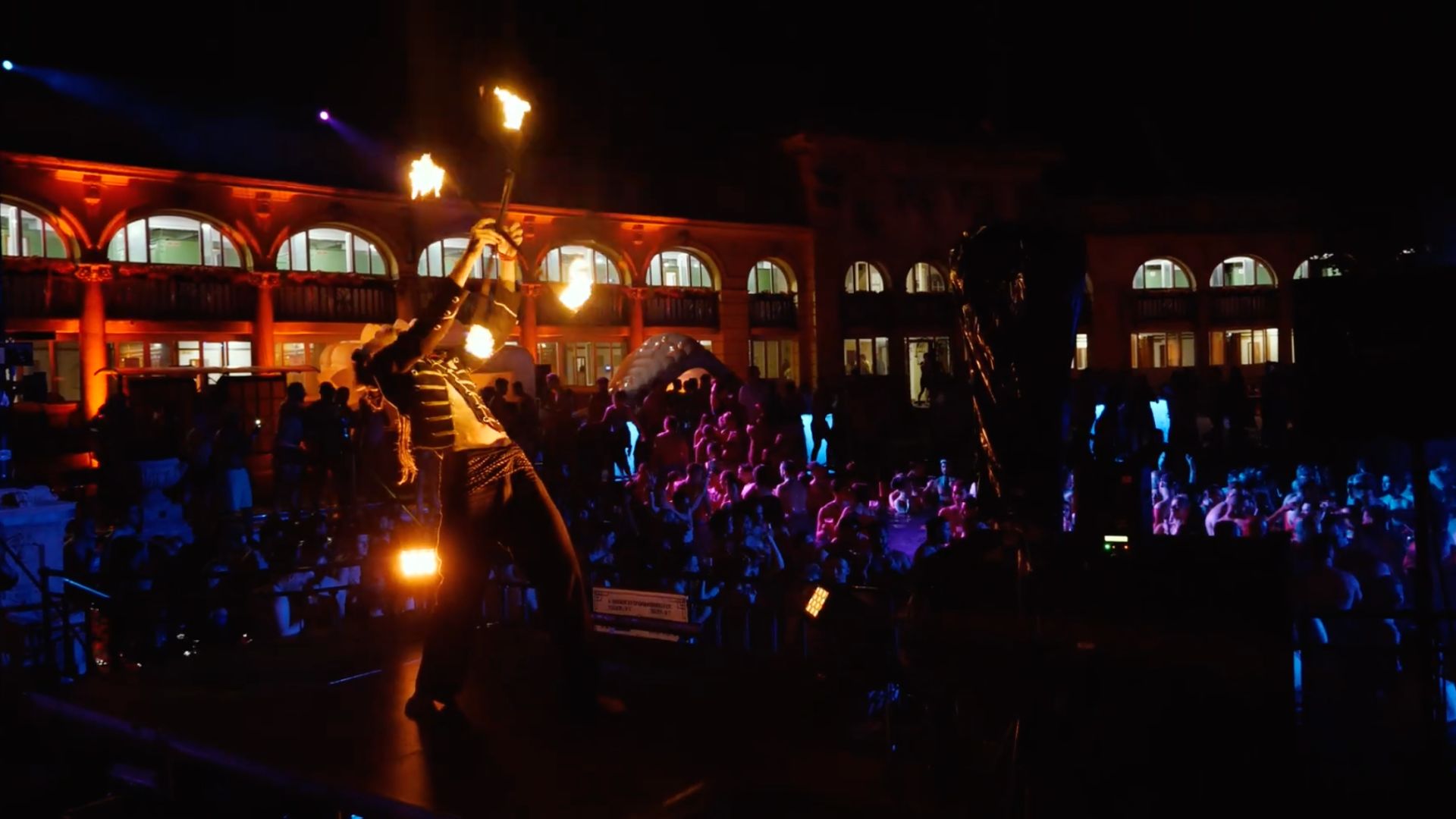 Nighttime performance with fire dancers at Széchenyi Sparty event