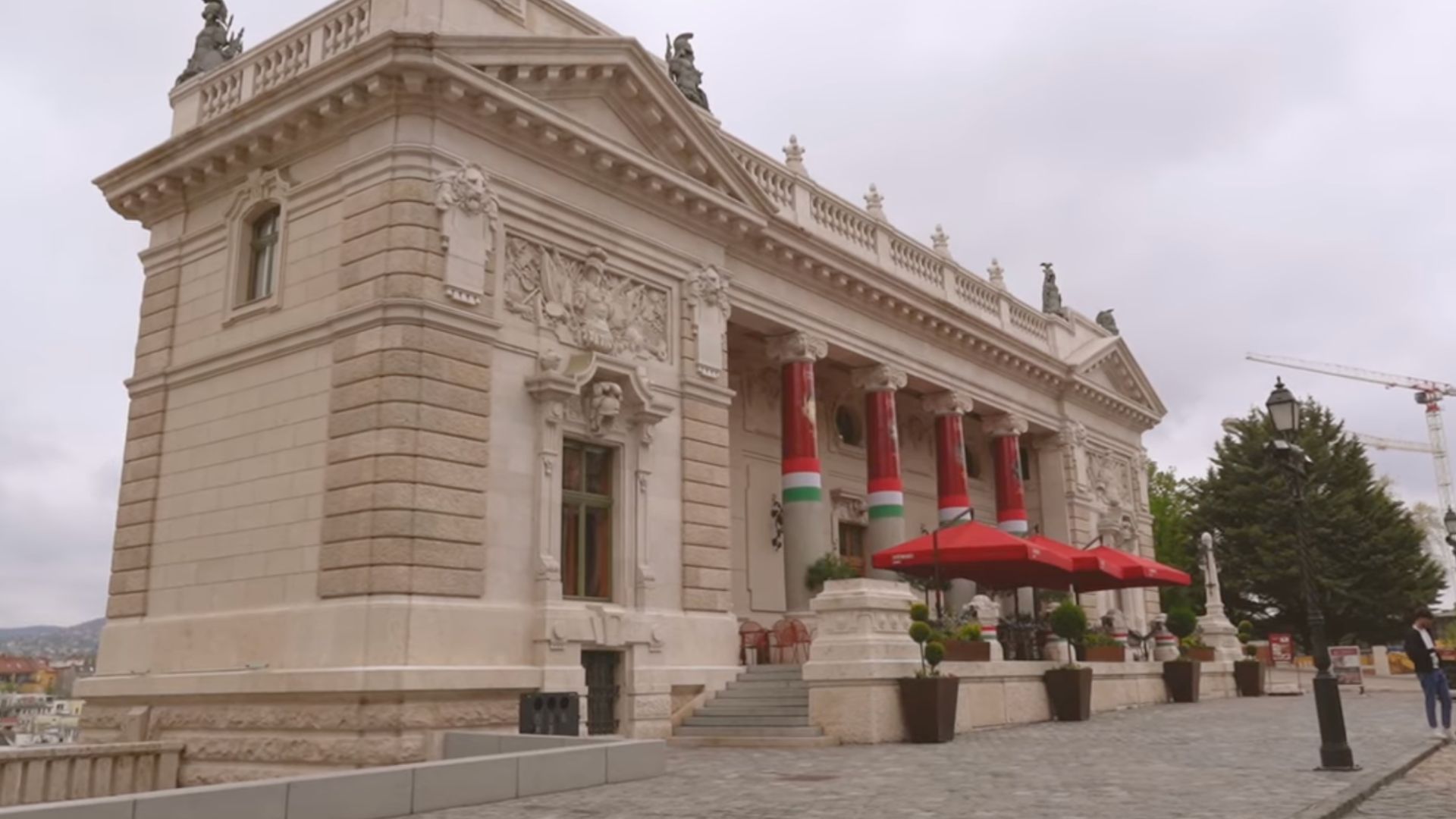 Royal Palace building in Budapest with Hungarian flags.