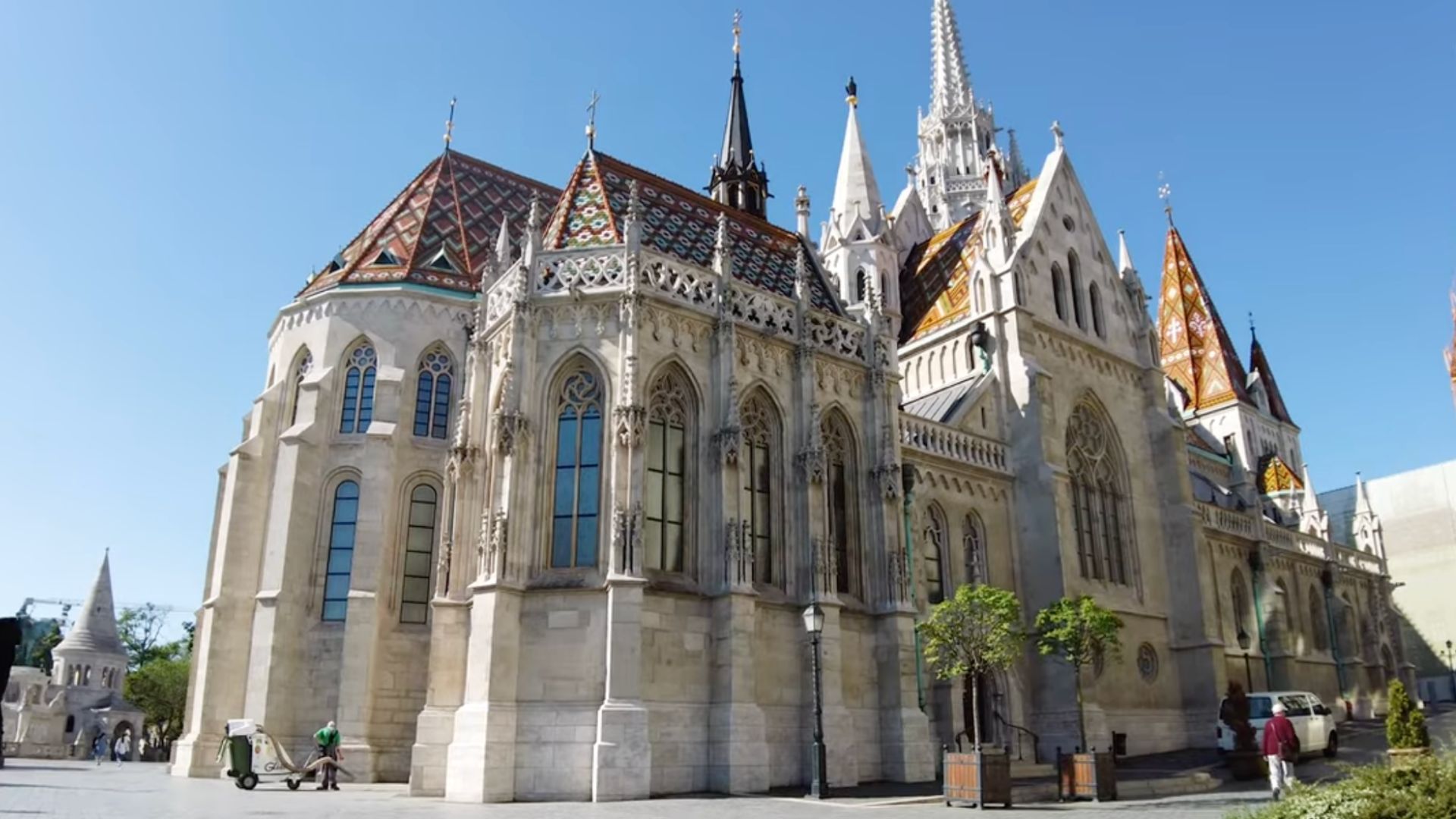 The vibrant, tiled roof and Gothic architecture of Matthias Church adjacent to Fisherman's Bastion.